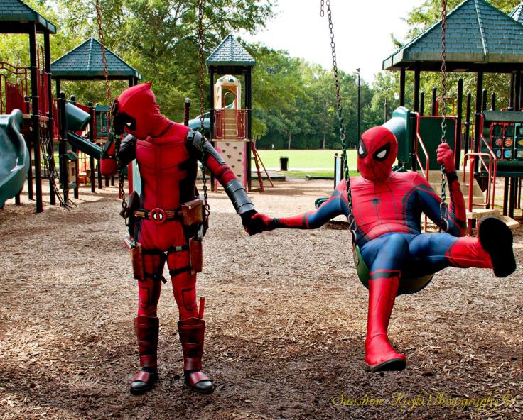 Spider-Man x Deadpool holding hands on swings, facepalm